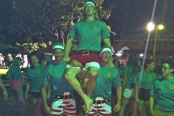 Elves carry Walt to
          caroling