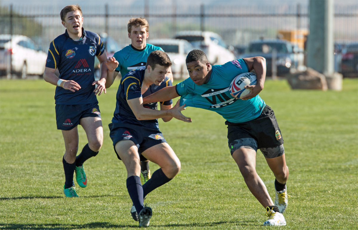 Jayden fends off
              defender